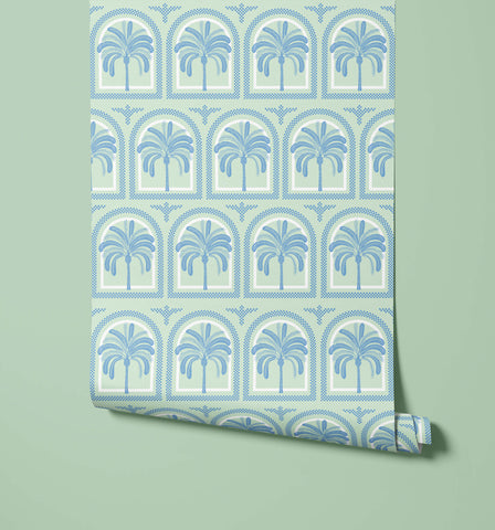 A roll of tucci mint green wallpaper with a repeating blue palm tree pattern in arched frames perfect for walls