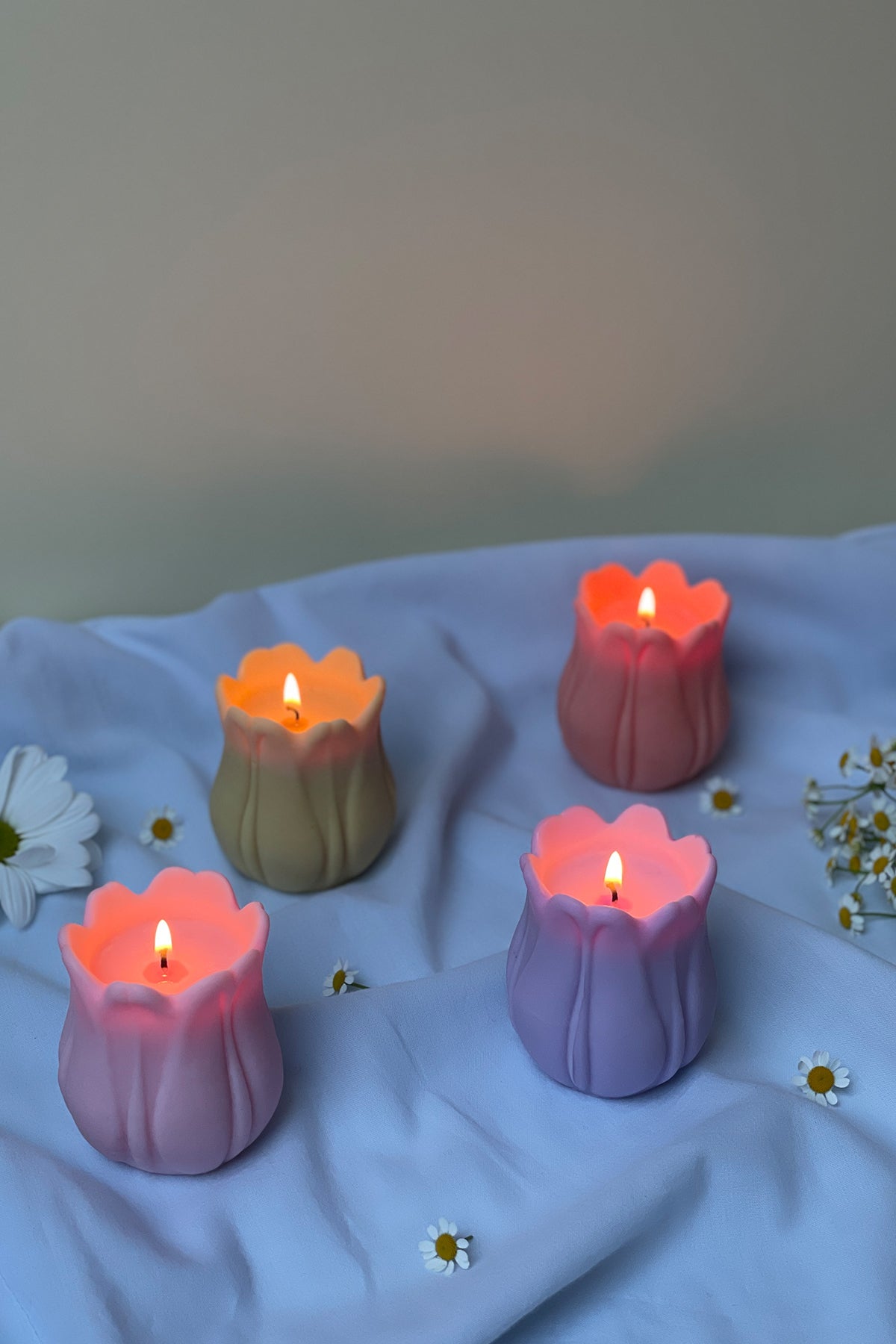 Pastel-colored tulip shaped candles with soft glowing flames perfect for cozy home decor and gifts