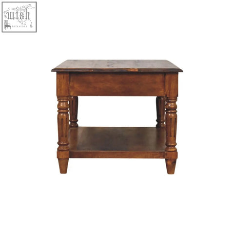 A rustic brown wooden drawer coffee table with turned legs and a lower shelf perfect for living room use