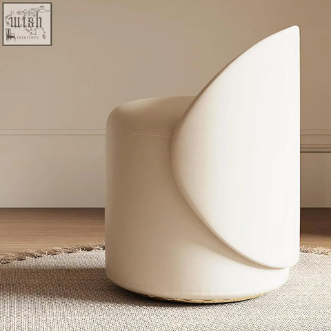 Cream-colored upholstered stool with curved backrest and rounded edges for turner dressing table setup