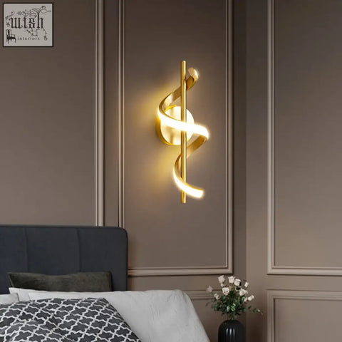 Gold-toned twisted led wall light with sleek spiraling design providing warm ambient lighting for living room