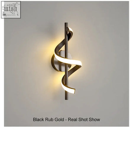 A sleek twisted led wall light with black and gold metallic finishes perfect for living room wall light setup