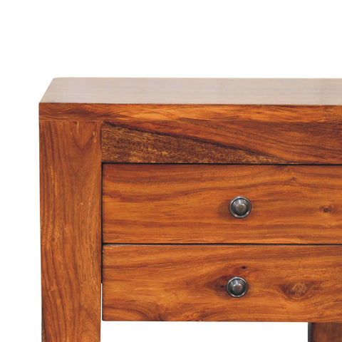 Rich warm-toned honey bedside table made of solid sheesham wood with two drawers and dark metal knobs