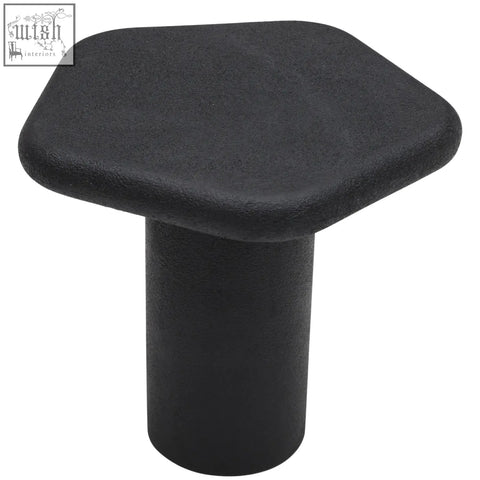 Black hexagonal plastic cap with rounded edges and cylindrical base for udaipur pentagon end table leg protection