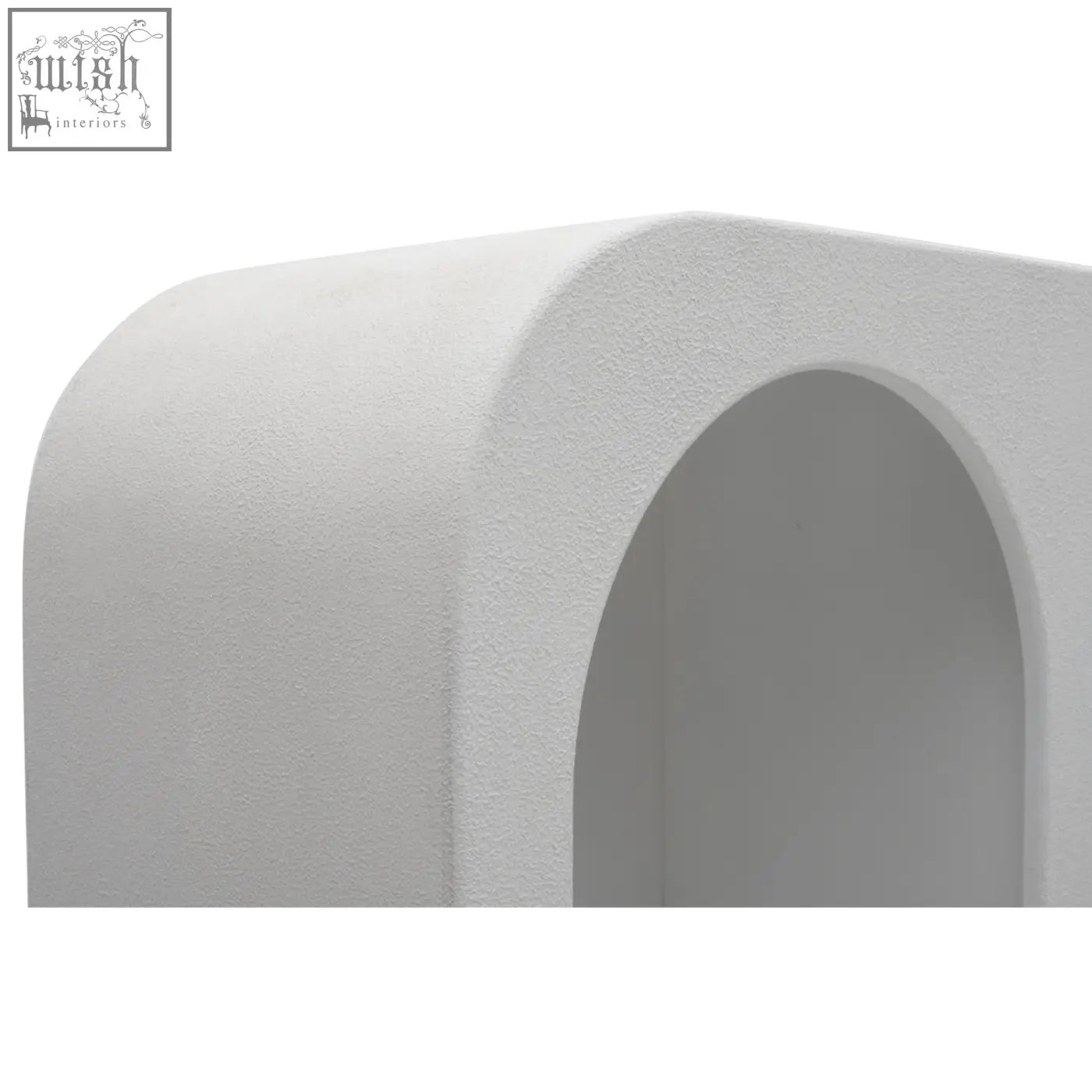 White textured concrete archway highlighting udaipur tall geometric open shelving bookcase design detail