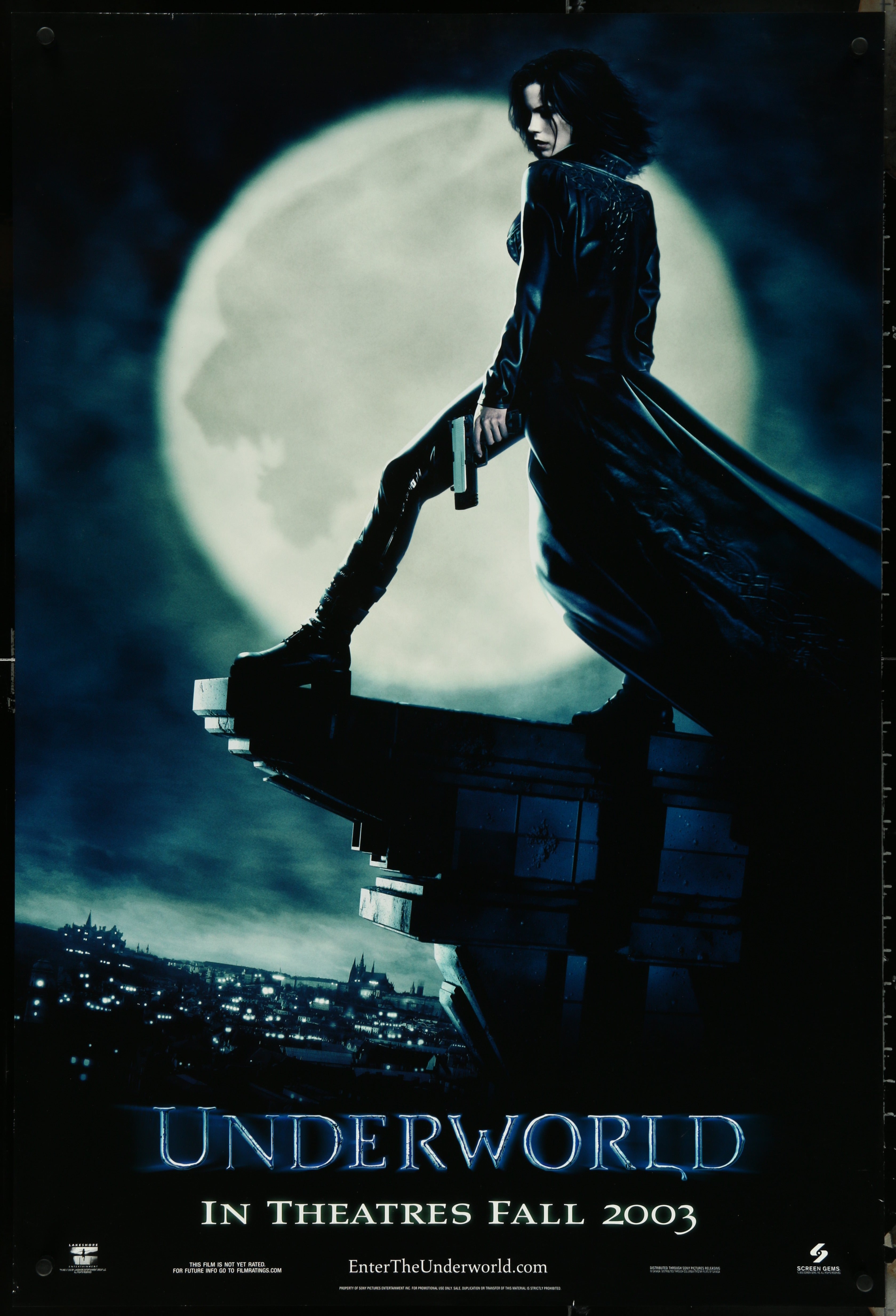 Dark long coat with high collar and subtle details on character in front of large moon in underworld 2003 movie poster