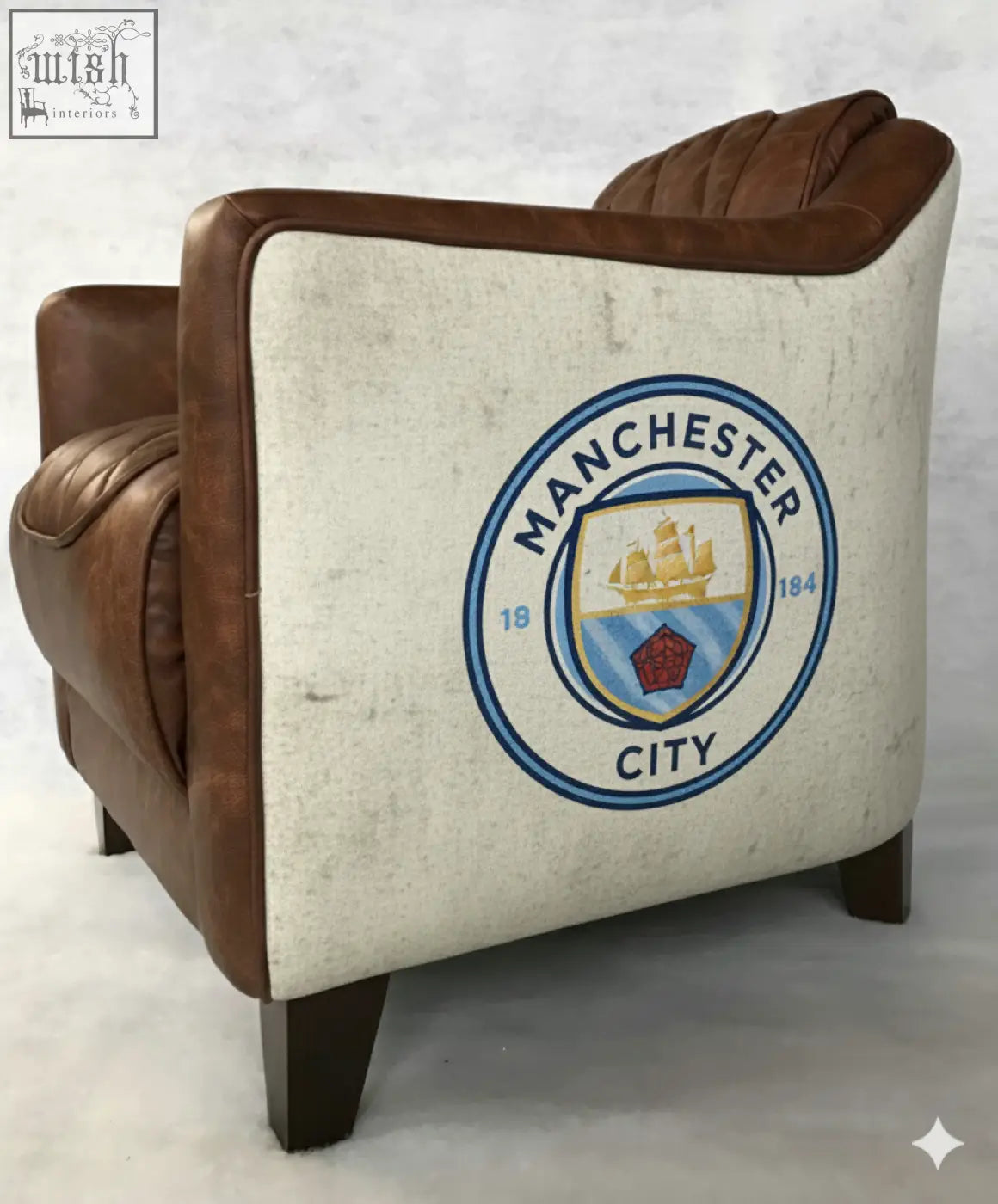 Brown leather union tub chair showing cream back panel with manchester city fc crest on the back side