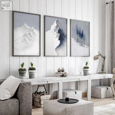 Three framed mountain landscape wall art prints in muted grey white and blue tones for living room decor