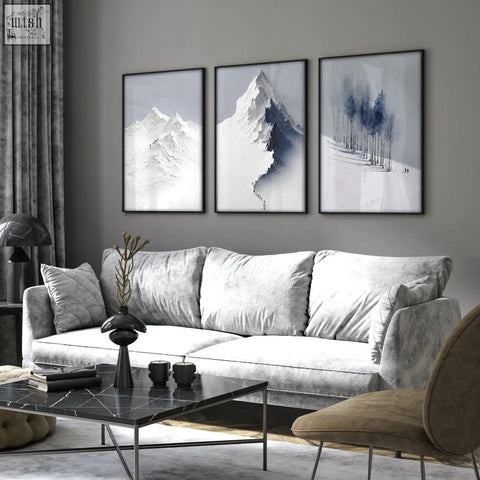 Gray velvet sofa with plush cushions next to unusual scandi nordic mountain landscape wall art for living room
