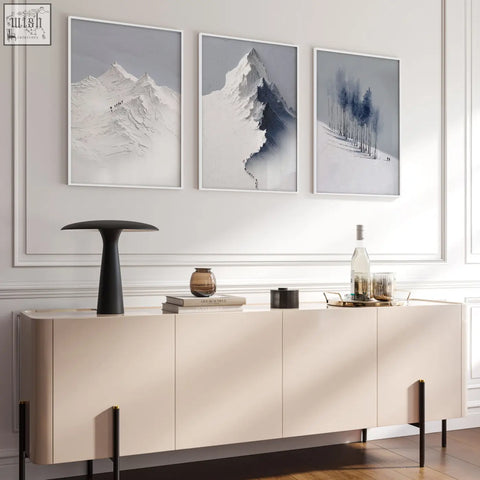 Beige minimalist sideboard with flat-panel doors and black legs below scandi nordic mountain landscape wall art set in living room