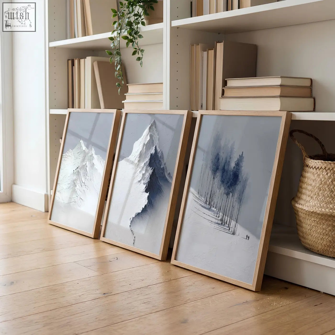 Three framed minimalist mountain landscape wall art prints in blue gray tones with light wood frames for living room