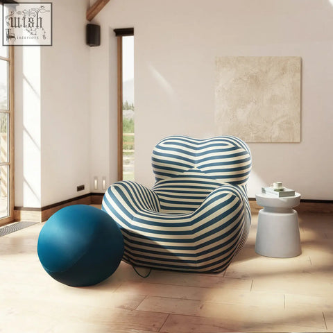 A plush up50 armchair lounge chair with bold blue and white horizontal stripes and a matching ball stool