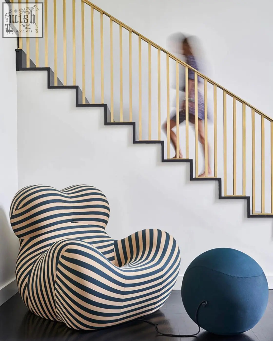 A plush up50 armchair lounge chair with bold navy and cream horizontal stripes and an organic shape