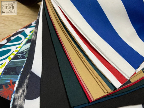 A stack of colorful striped fabric samples including blue and white for the up50 armchair b&b italia style in red