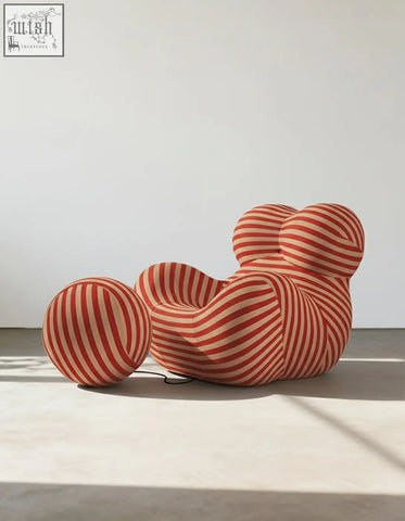 A plush up50 armchair with a rounded cloud-like design and red cream stripes in b&b italia style