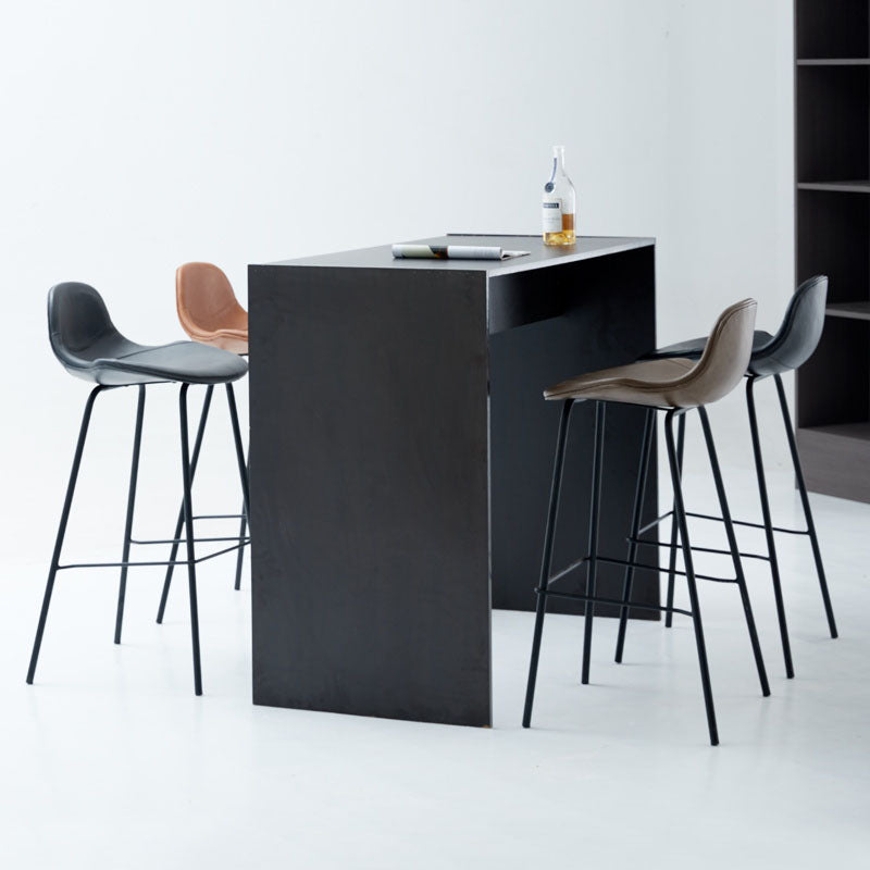 Black minimalist bar table with smooth surface paired with upton nordic bar leather stool for modern spaces