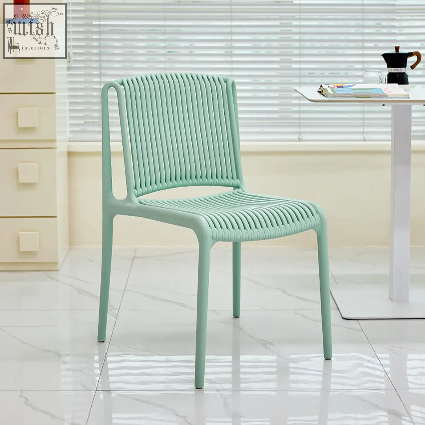 A mint green upton plastic dining chair with a woven ribbed design perfect for casual dining spaces