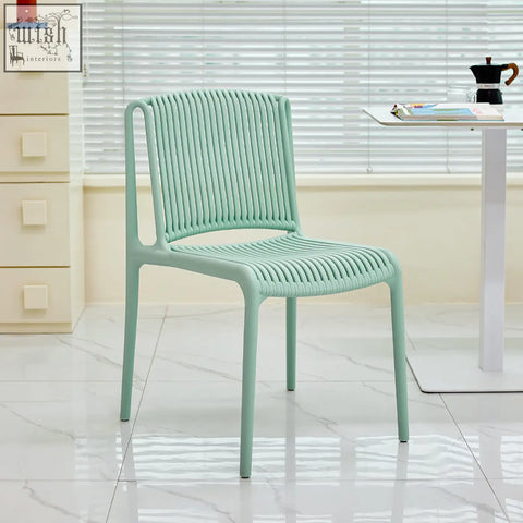 A mint green upton plastic dining chair with a woven ribbed design perfect for casual dining spaces