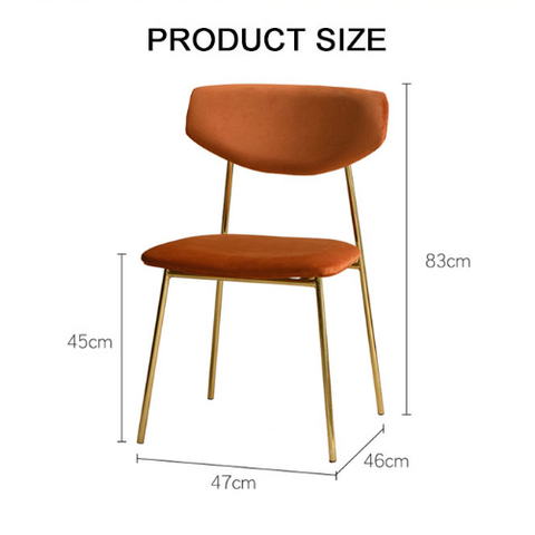 Urban dining chair with plush orange velvet seat and backrest supported by slim gold-toned metal legs
