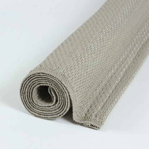 A rolled beige woven urban outdoor rug with a textured interlaced pattern perfect for outdoor use