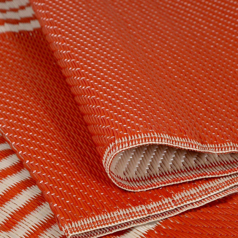 Orange woven urban outdoor rug terra with textured pattern and white stitching perfect for outdoor use