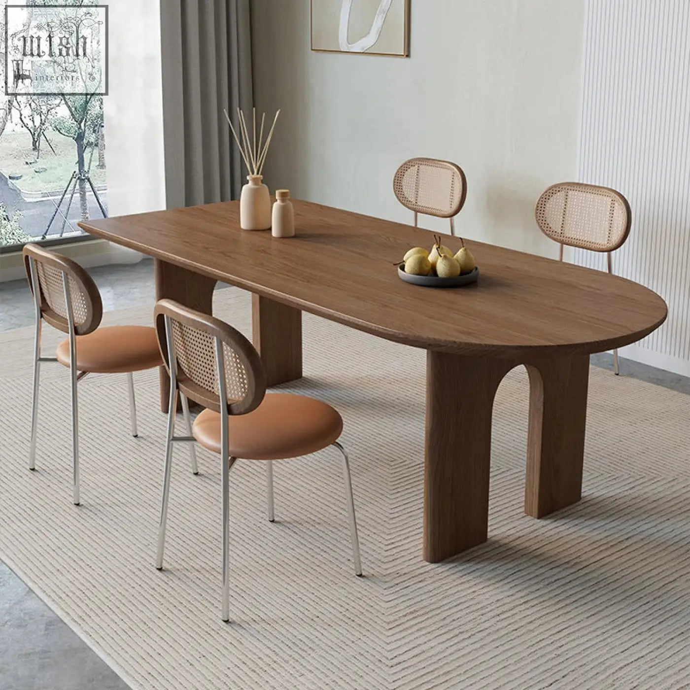 Modern uta dining table with warm brown wood finish and arched legs paired with woven back chairs for dining use