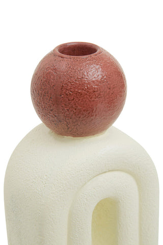 A terracotta utica candle holder with textured spherical vase and cream sculpted base perfect for candles