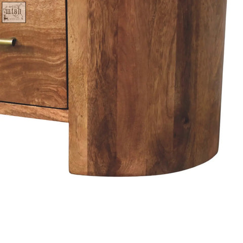 A curved valencia sculpted bedside wooden cabinet with warm brown finish and natural wood grain visible