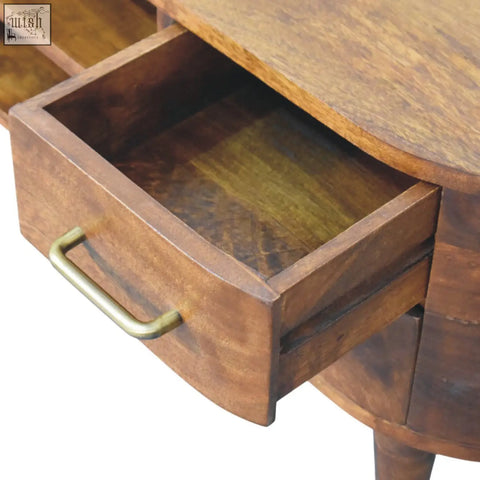 A warm brown wooden drawer with brass handle and visible wood grain in the valenza curved media unit