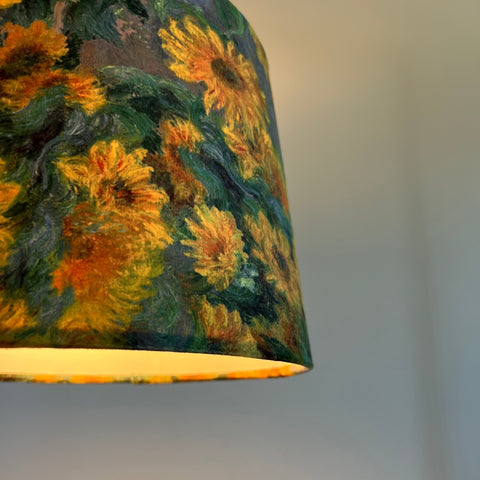 A van gogh french drum lampshade featuring vibrant sunflowers in golden yellow velvet with a metallic brushed finish