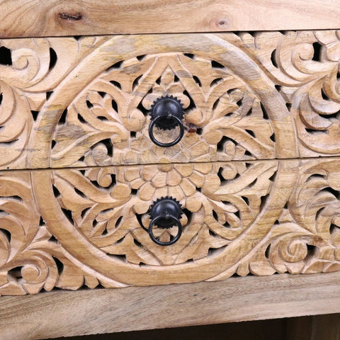 Light wood vansura carved bedside table with black metal ring pulls and intricate floral patterns and 2 drawers