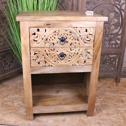 A light wood vansura carved bedside table with two intricately carved drawers and black metal ring pulls bedside table