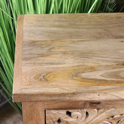 A vansura carved bedside table with two drawers in rustic light brown wood finish and visible grain patterns