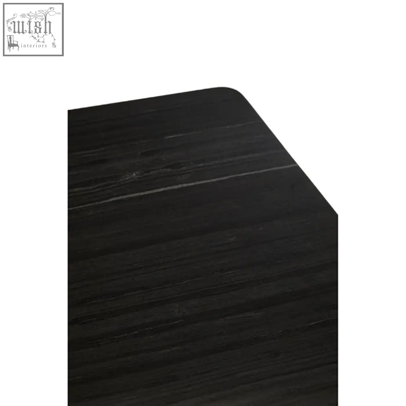 Corner of varana black marble dining table showing smooth black wooden edge with dark finish and visible grain texture
