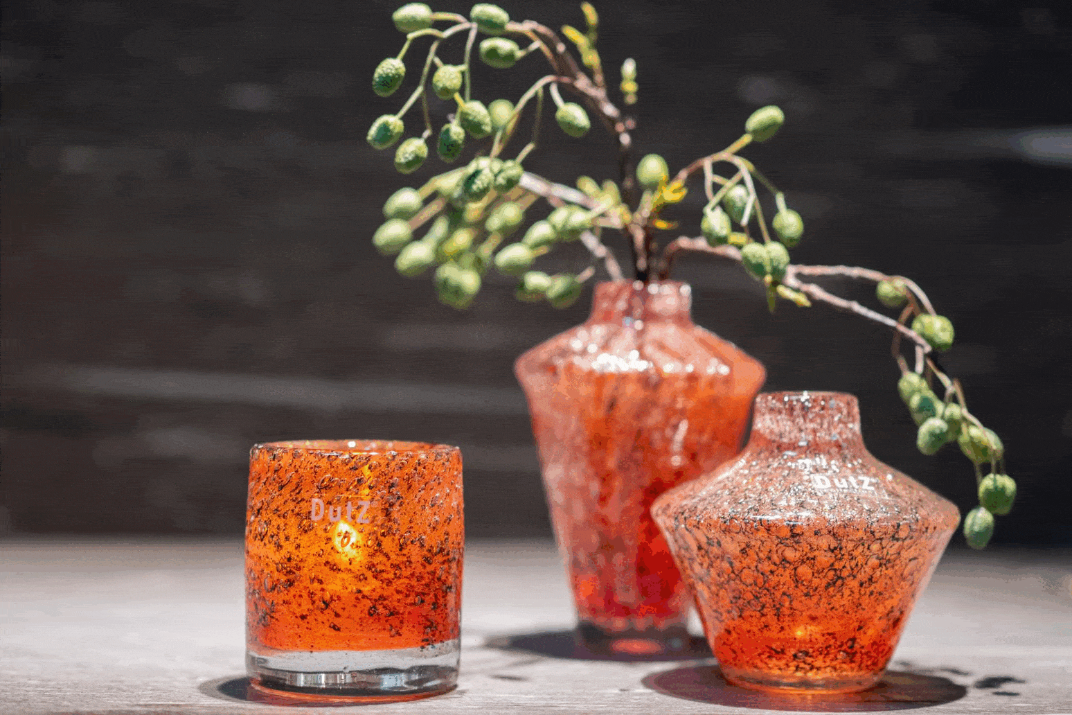 Orange glass candle holders from dutz collection with speckled textured surface and subtle amber glaze mouth blown glass