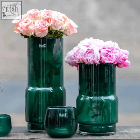 Dark green vase fenn from dutz collection mouth blown glass with vertical ridges holding pink roses