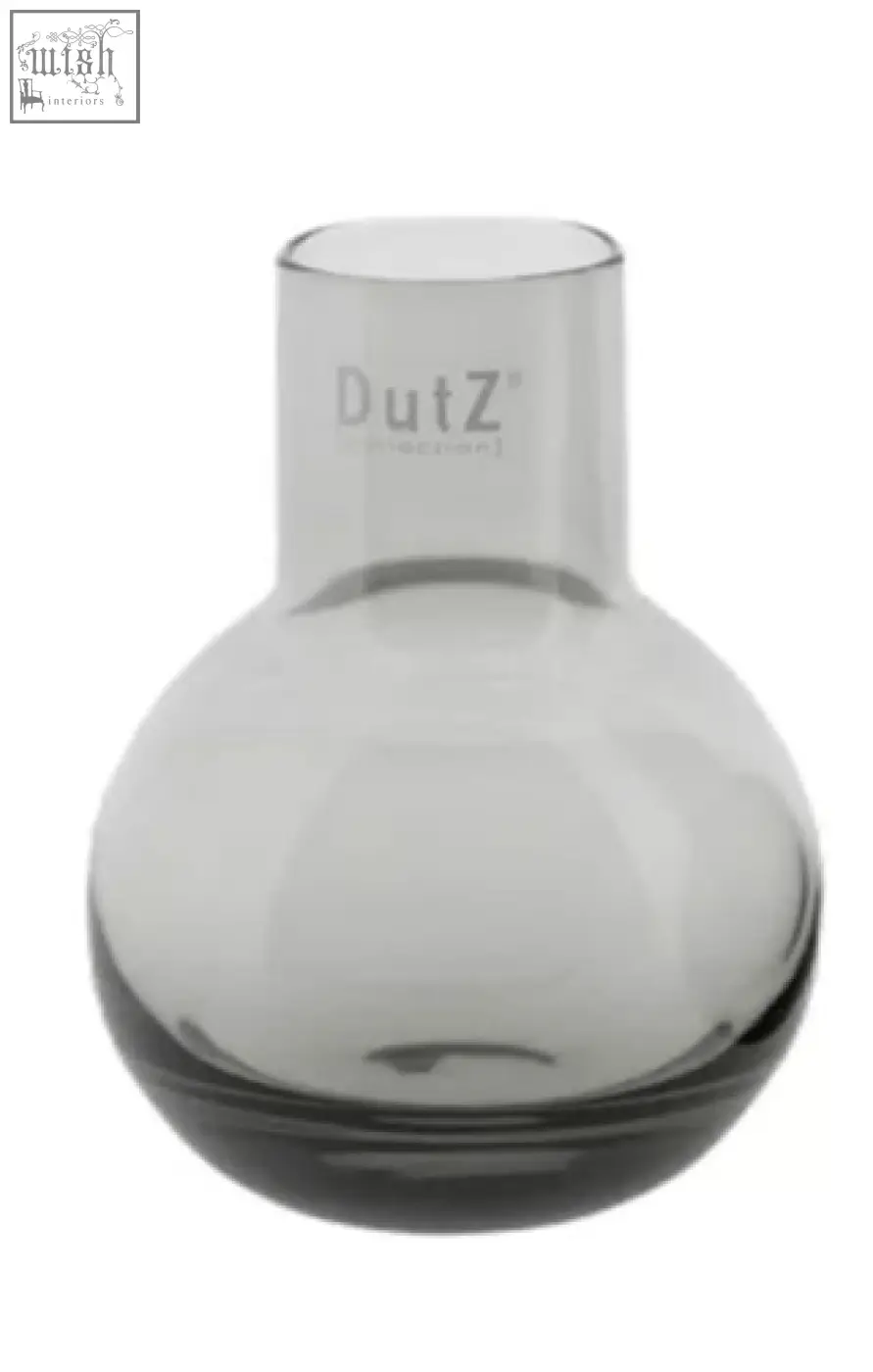 A sleek translucent gray glass vase from dutz collection made of mouth blown glass with a rounded body and narrow neck