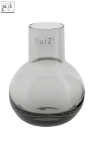 A sleek translucent gray glass vase from dutz collection made of mouth blown glass with a rounded body and narrow neck