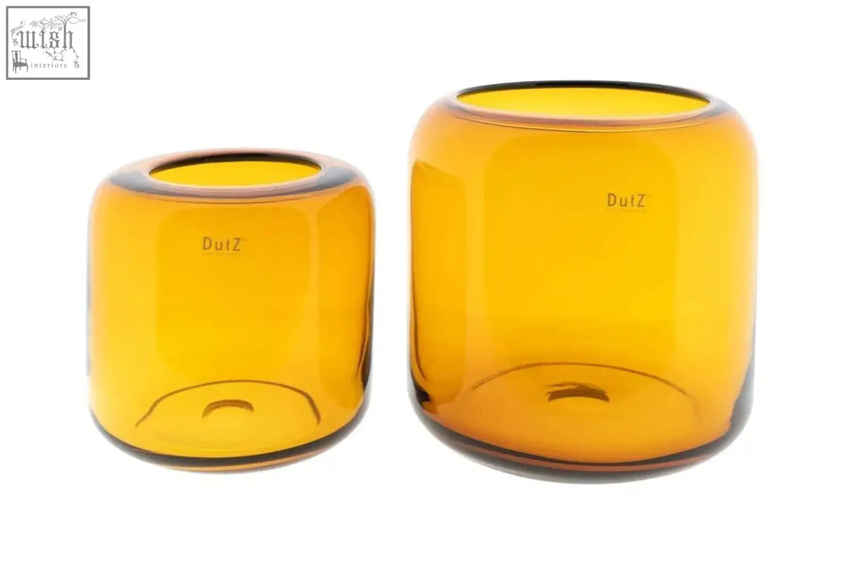 Two mouth blown amber glass vases from the dutz collection with smooth rounded shapes and dutz etched on their sides