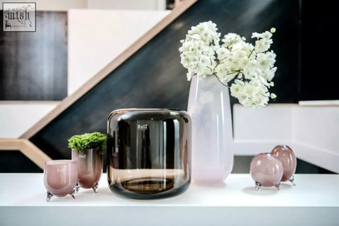 A sleek mouth blown glass vase in smoky brown from the dutz collection with a rounded rectangular shape and reflective surface