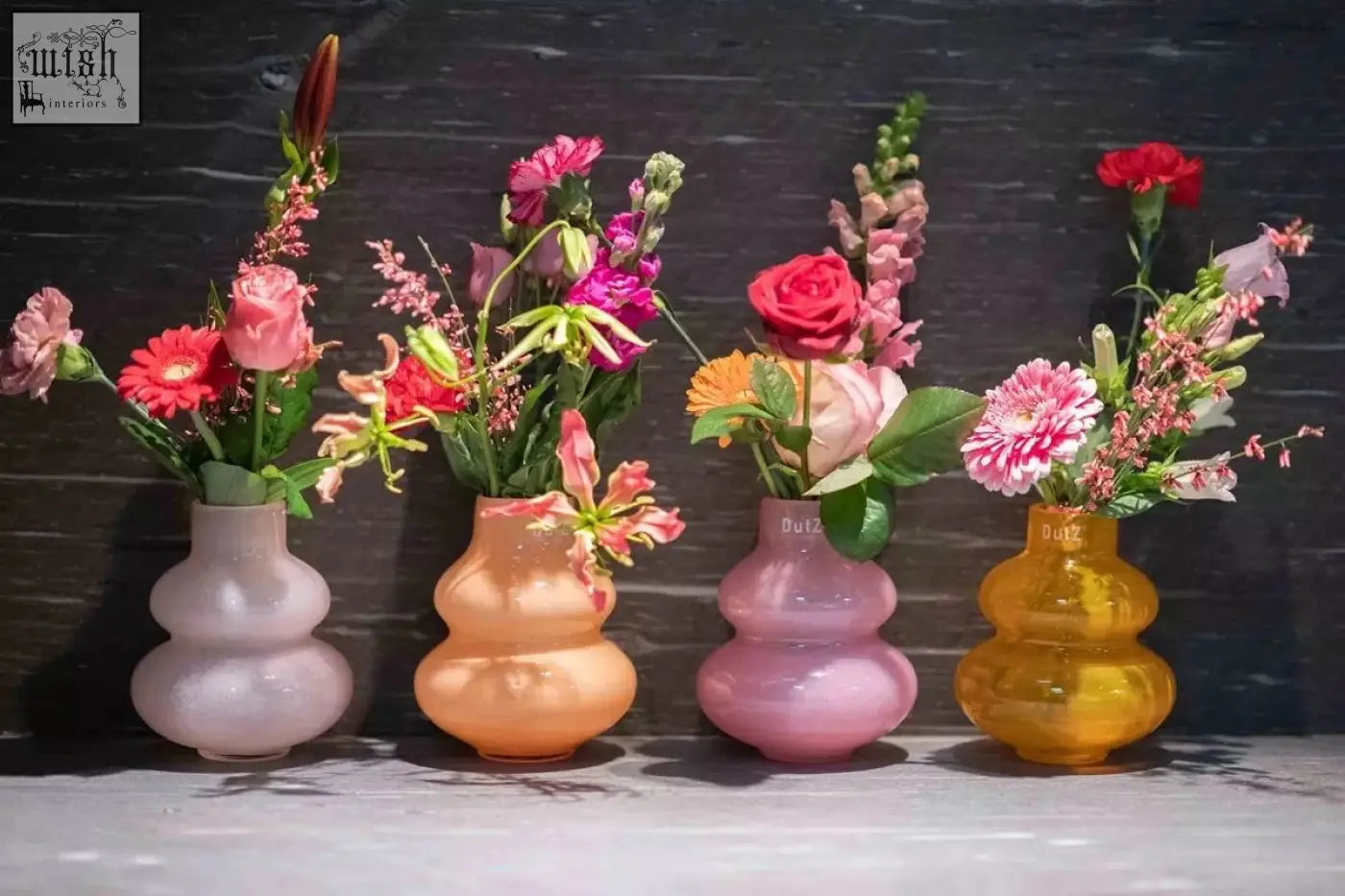 Four pastel-colored mouth blown glass vases in a distinctive double-gourd shape from the dutz collection