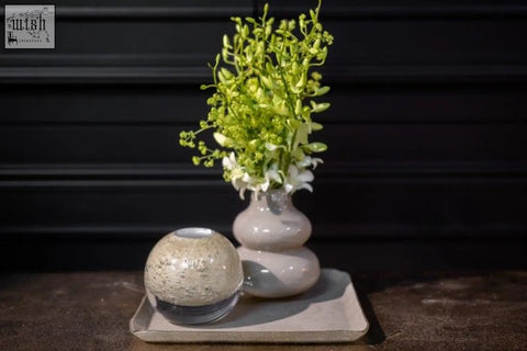 A sleek two-toned ceramic vase skrzyszow h16 d14 cm with green orchids from dutz collection mouth blown design