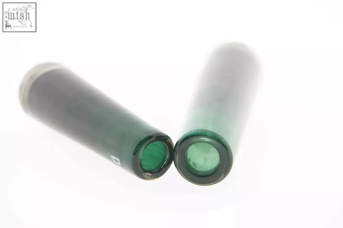 Two translucent green mouth blown glass vases with dark bases from the dutz collection solifleur budvase dark green