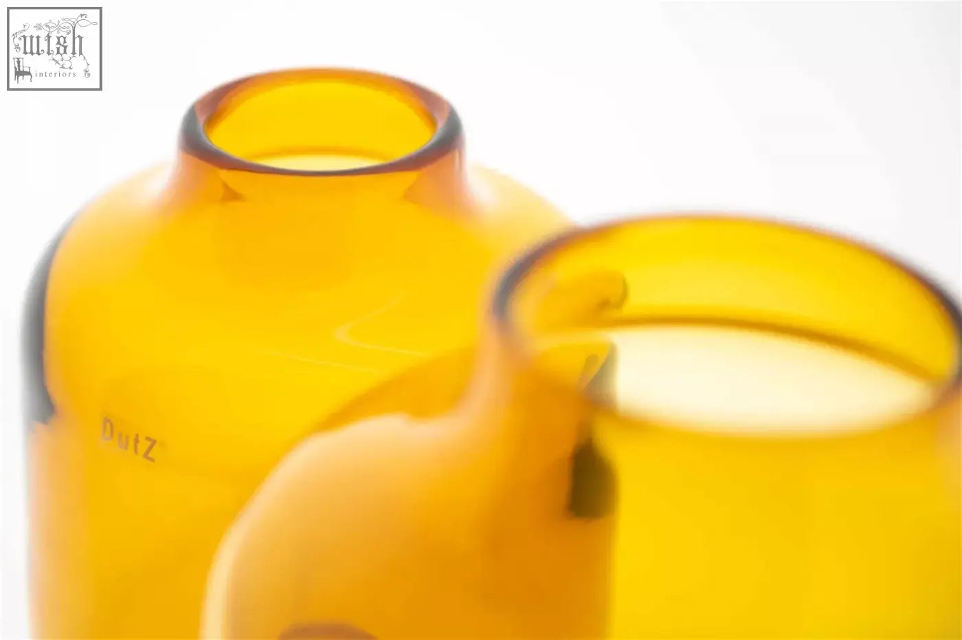 Amber-colored mouth blown glass laboratory bottles with smooth rounded design from dutz collection vase tisza amber