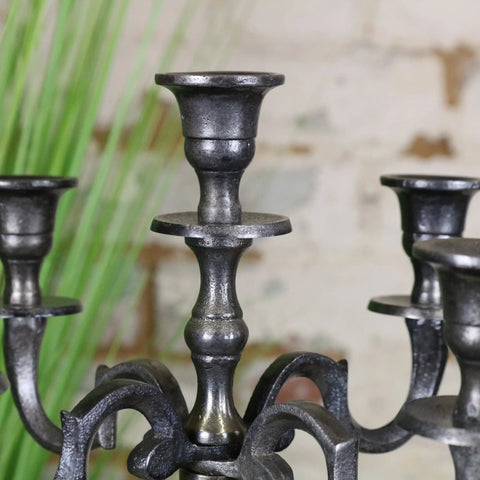 Black wrought iron veeha candelabra centerpiece with ornate scrolled arms in gunmetal silver matte finish