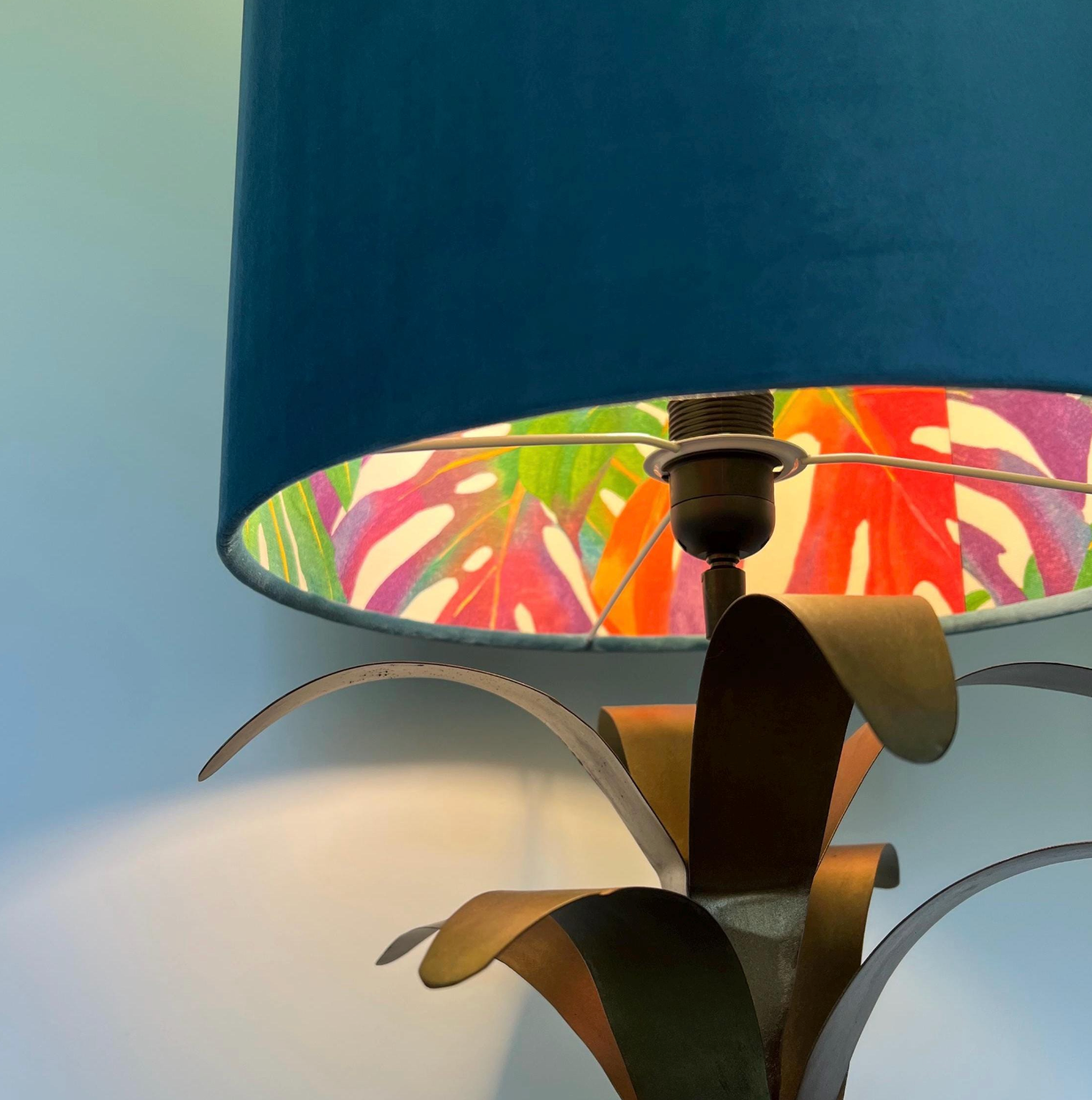 Velvet double sided drum lampshade with tropical leaf pattern and deep blue fabric on metallic palm base ceiling light shade