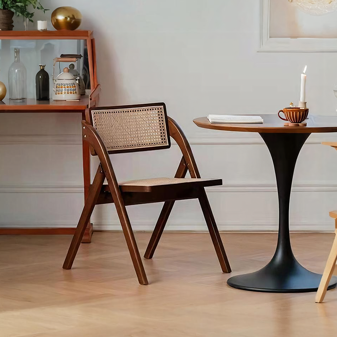 A dark wood vera foldable rattan dining chair with rubber wood frame and woven cane back and seat