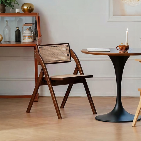A dark wood vera foldable rattan dining chair with rubber wood frame and woven cane back and seat