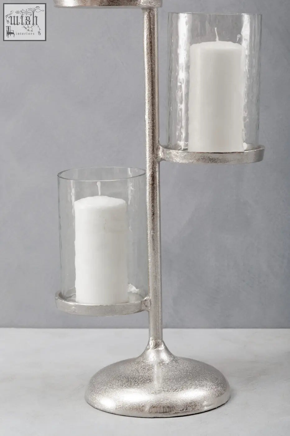 Silver-toned metal verve floor standing 3-light candle holder with two clear glass cylinders holding white pillar candles