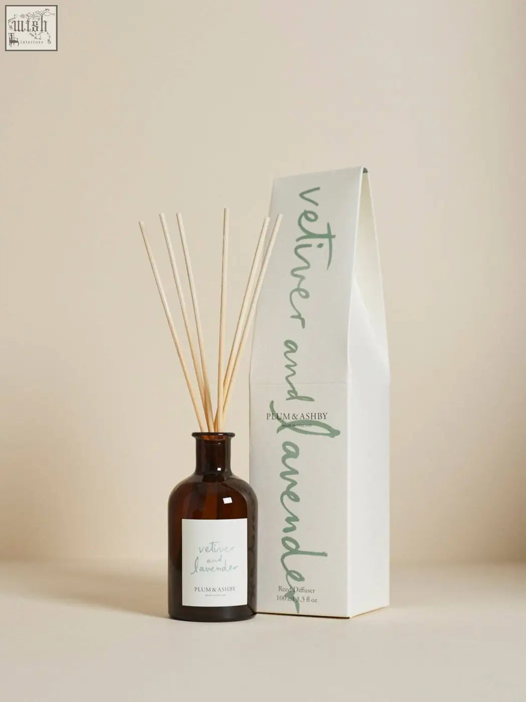 Brown glass vetiver and lavender diffuser with slender wooden sticks and minimalist white label using vegetable oil base